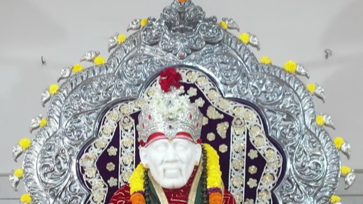 The marble murti of Shirdi Sai Baba within its silver prabhavali.