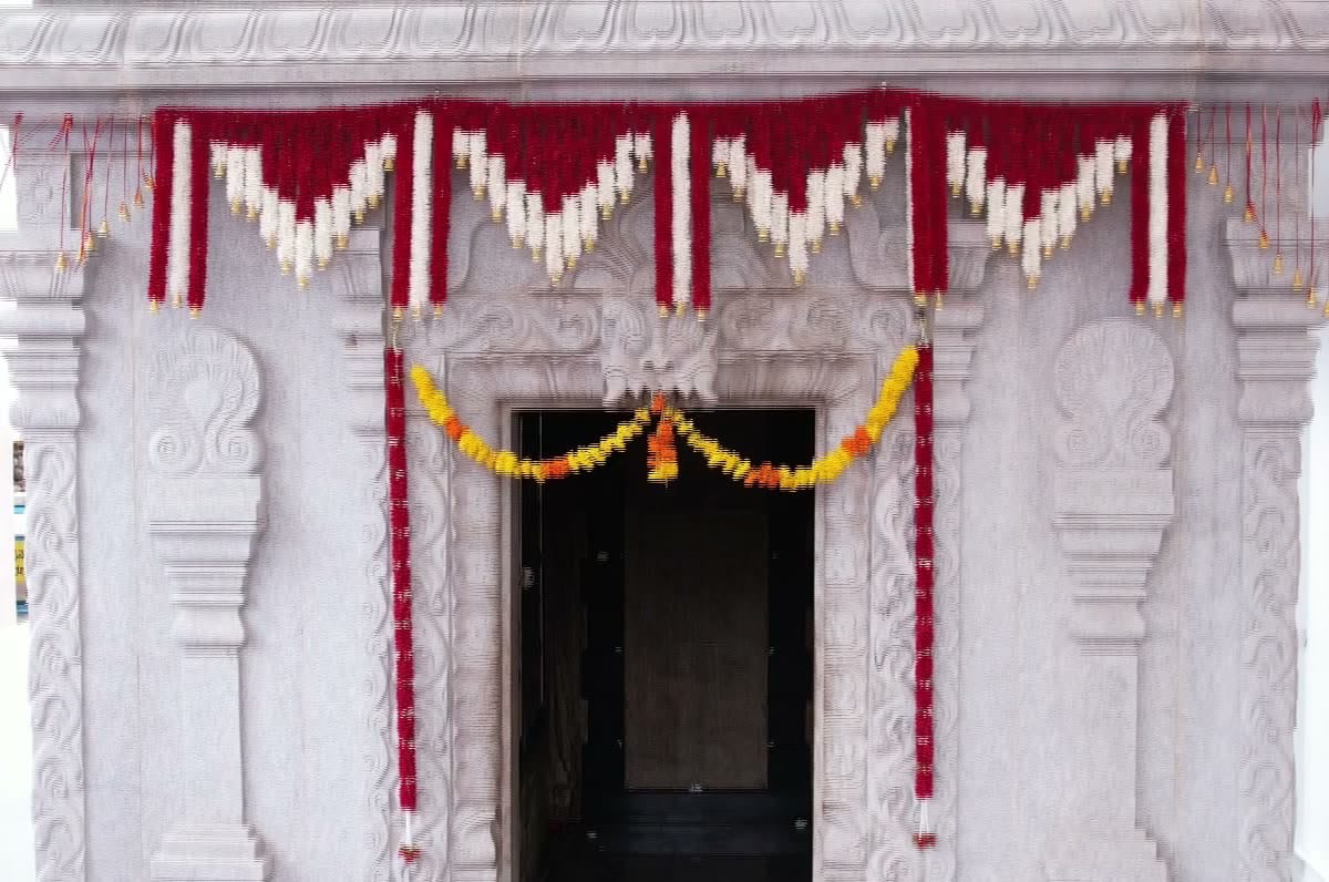 The garlanded doorway of the Dwarakamai, the shrine within the precinct where the dhuni burns.